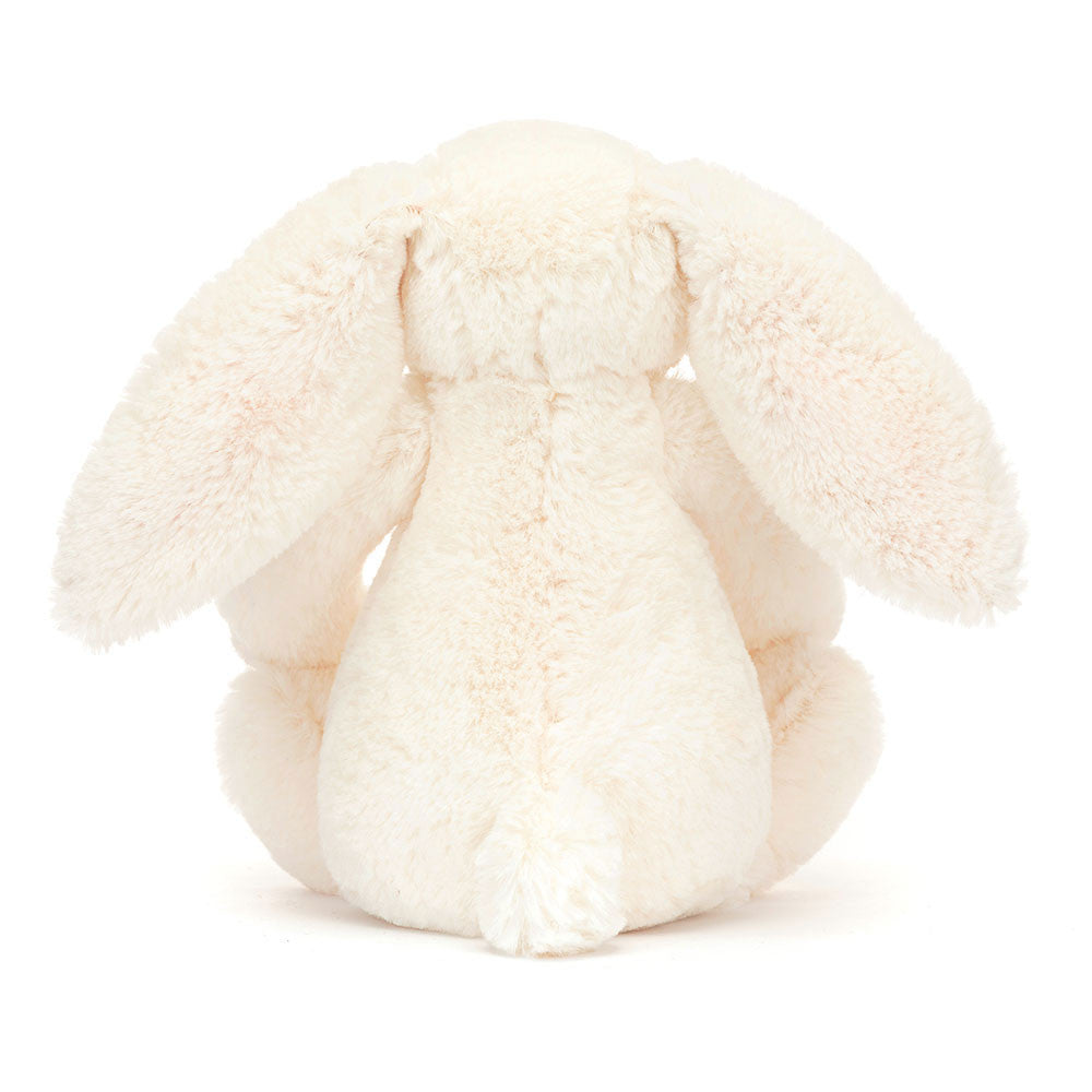 White plush bunny toy on a white background - behind