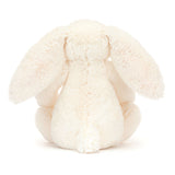 White plush bunny toy on a white background - behind