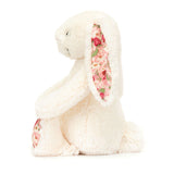 Side view of White plush bunny with floral ears on a white background side