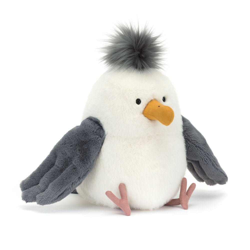 Plush toy sea gull with gray wings and a white body on a white background