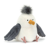 Plush toy sea gull with gray wings and a white body on a white background