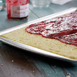 Doughmakers Jelly Roll Pan with someone preparing a jelly roll