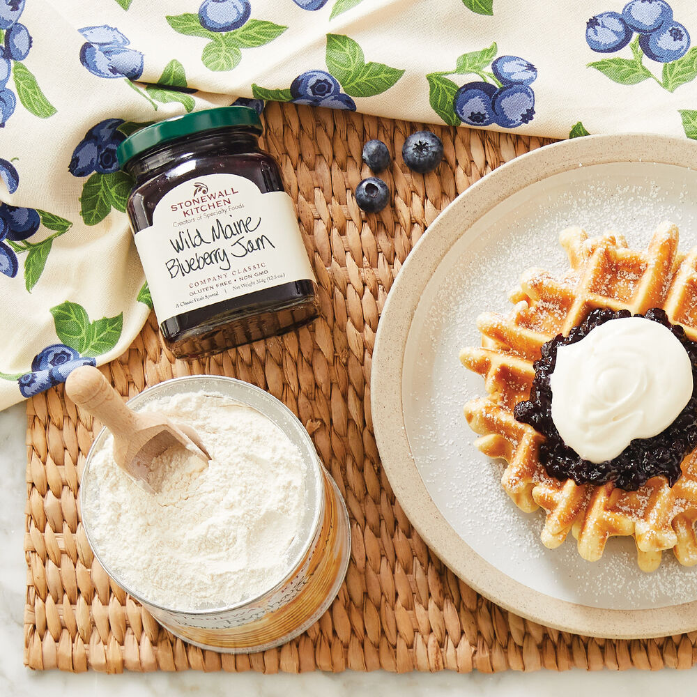 Stonewall Kitchen's Wild Maine Blueberry Jam on a waffle with powdered sugar