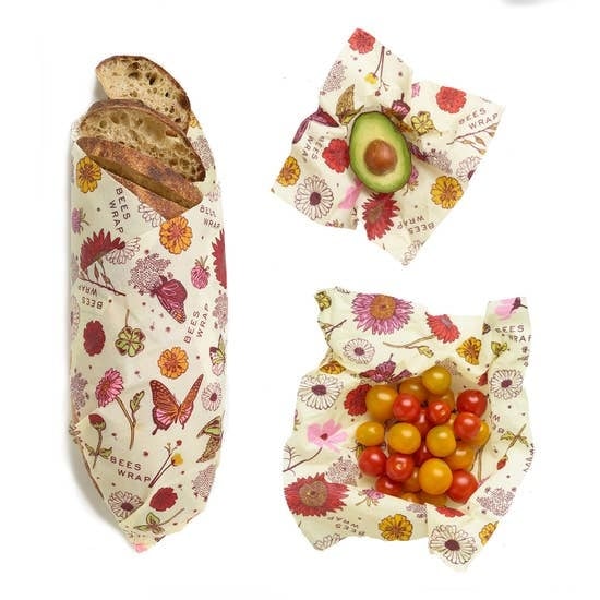 Bees Wrap Assorted 3 Pack (S, M, L) Meadow Magic wrapping a loaf of bread, some cherry tomatoes, and half of an avocado