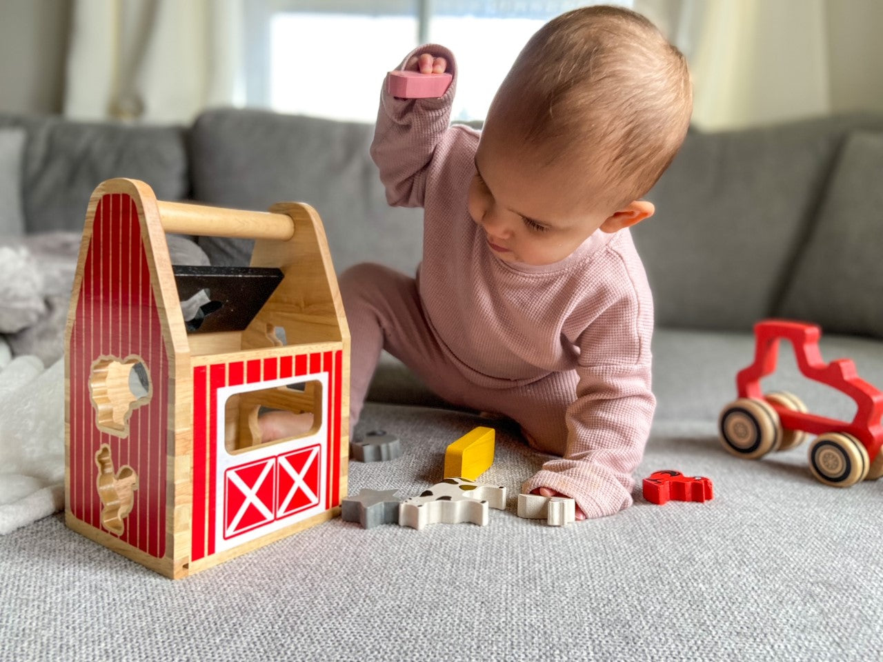 Child playing with Begin Again Barnyard Shape Sorter