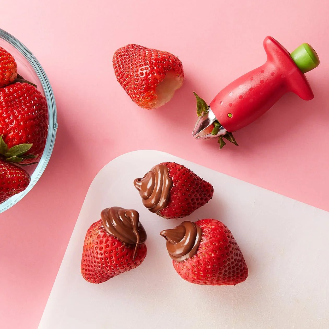 Chefn StemGem Strawberry Huller with chocolate filled strawberries and an empty strawberry waiting for chocolate