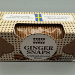 Box of Almond flavored ginger snaps with a clear window showing the cookies inside, on a gray background.