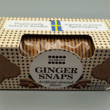 Box of Almond flavored ginger snaps with a clear window showing the cookies inside, on a gray background.