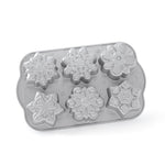 small cakes in the snowflake shapes on a white background