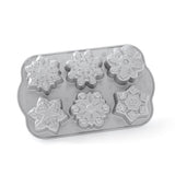 small cakes in the snowflake shapes on a white background