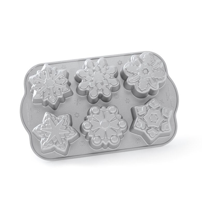 small cakes in the snowflake shapes on a white background