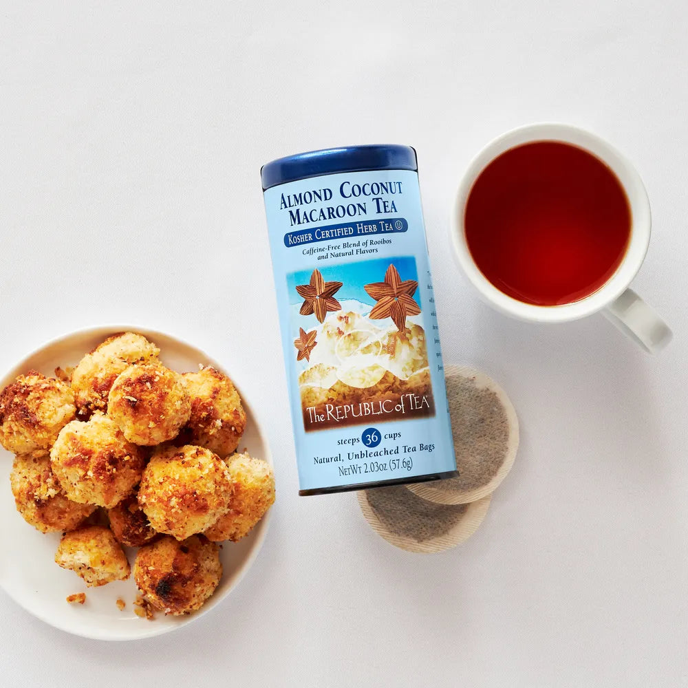 Macroons, Can of Almond Coconut Macroon Tea and tea bags and a cup of tea.