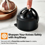 Black knife sharpener on a marble surface with garlic in the background, featuring AnySharp branding.