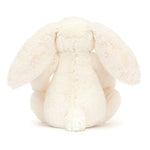 White plush bunny toy on a white background - behind