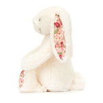 Side view of White plush bunny with floral ears on a white background side