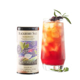 Picture of a can of Republic of Tea Blackberry Sage Tea Can and a glass of Blackberry Sage Ice Tea with blackberries