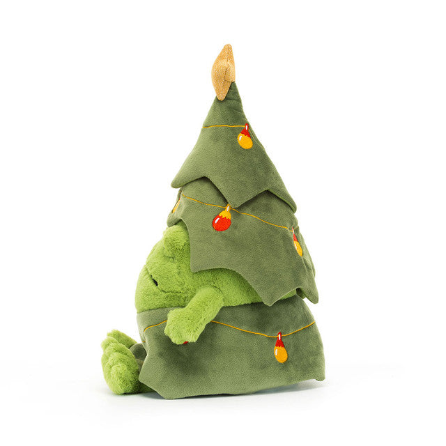 Sideview of Plush toy frog with a grumpy face dressed as a Christmas tree with lights and a star on a white background