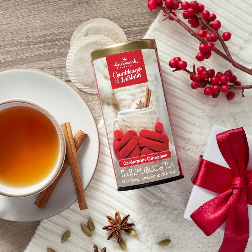  Picture Republic of Tea Cardamom Cinnamon Tea Can with tea bags, a cup of tea, cinnamon sticks, and a gift with red bow