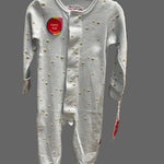 A baby long-sleeve footed sleeper in light gray with small gold embroidered details, shown hanging on a store display.