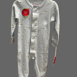 A baby long-sleeve footed sleeper in light gray with small gold embroidered details, shown hanging on a store display.