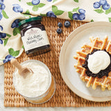 Stonewall Kitchen's Wild Maine Blueberry Jam on a waffle with powdered sugar 