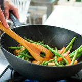 Zyliss 12.2 inch Ken Home Wok with stir fry vegetables being cooked in it.