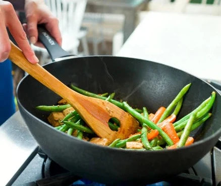 Zyliss 12.2 inch Ken Home Wok with stir fry vegetables being cooked in it.