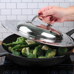 Picture of someone putting lid on top of a pan of broccoli