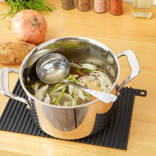 Ladle in pot of soup