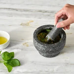 Zyliss Cole & Mason Mortar & Pestle with herbs and oil making salad dressing