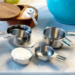 Stainless Steel Measuring Cups on counter with ingredients