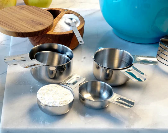 Stainless Steel Measuring Cups on counter with ingredients