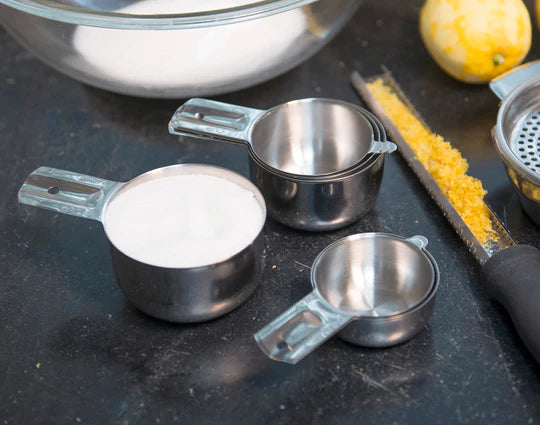 Stainless Steel Measuring Cups on counter with ingredients