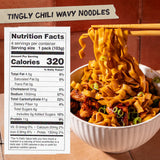 Bowl of Tingly Chili Wavy Noodles with nutrition facts label on a wooden background