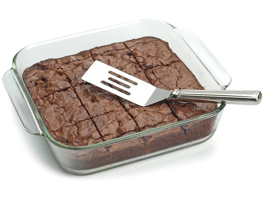 brownie server in a pan of cut brownies