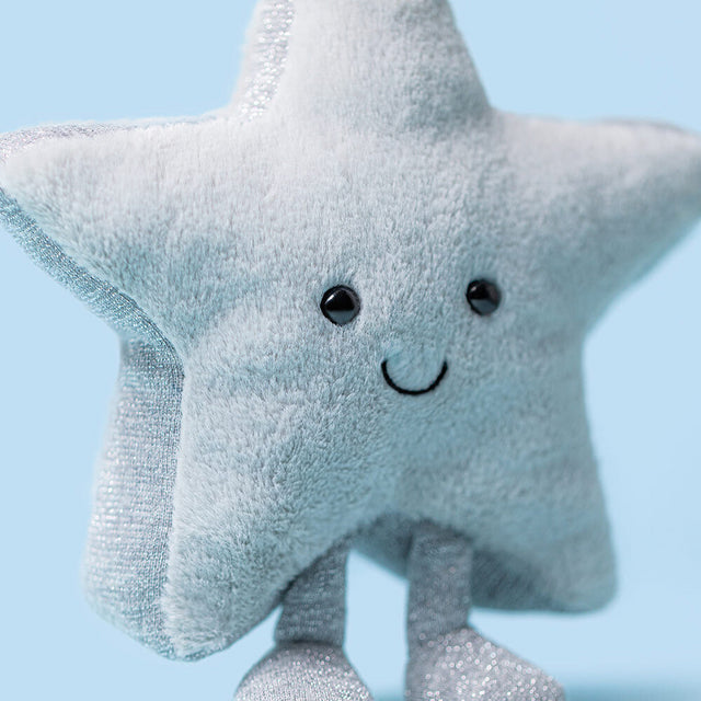 Plush star toy with a smiley face on a light blue background