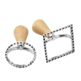 Two metal cookie cutters with wooden handles on a white background