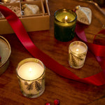 Thymes Frasier Fir Votives lit on table with decorations