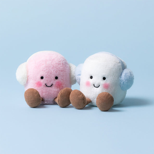 Two plush toys, one pink and one white, with brown feet on a light blue background