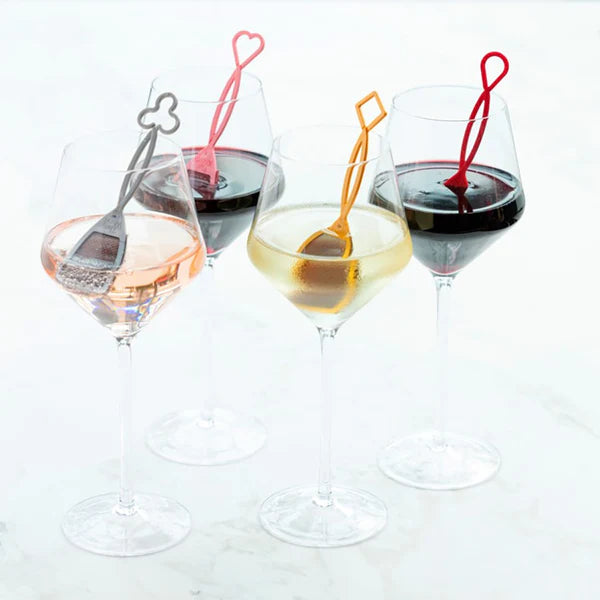 Picture of 4 different types of wine in 4 different glasses with each glass of wine containing  The Wand™ 