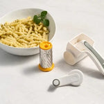 Zyliss Classic Cheese Grater with parts in front of bowl of pasta