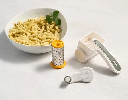 Zyliss Classic Cheese Grater with parts in front of bowl of pasta