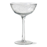 Clear glass cocktail glass with bubble texture on a white background