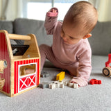 Child playing with Begin Again Barnyard Shape Sorter