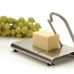 Cheese slicer with cheese and grapes