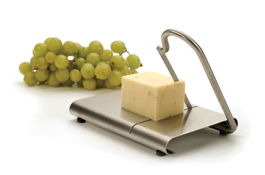 Cheese slicer with cheese and grapes