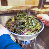 Kale being rinsed in colander