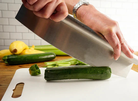 Pizza cutter cutting cucumber