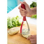 The Zyliss Stainless Steel Potato Masher mashing a potato