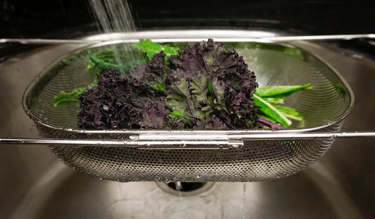 Stainless Steel Drainer-Strainer with lettuce being rinsed